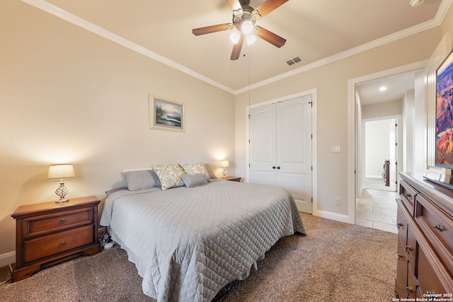 bedroom with ornamental molding, a closet, ceiling fan, and carpet