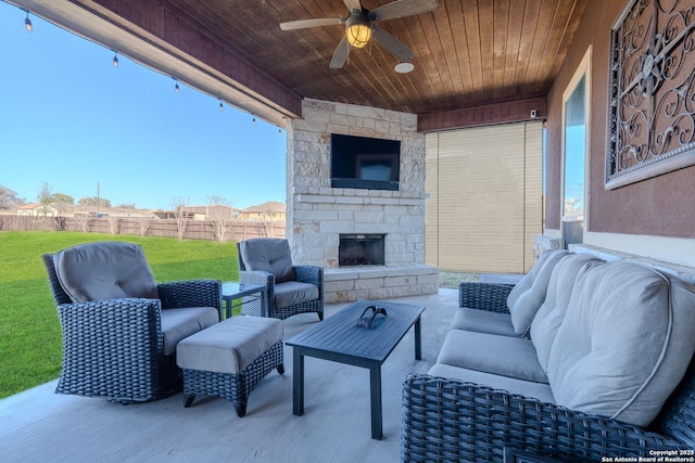 view of patio / terrace featuring an outdoor living space with a fireplace and ceiling fan