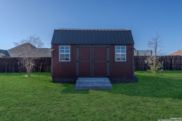 view of outbuilding with a yard