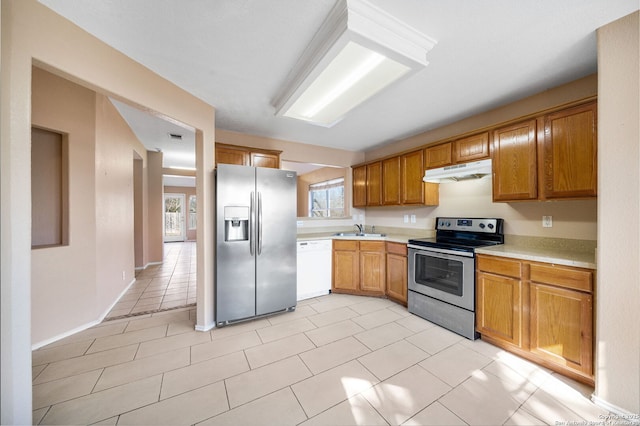 kitchen with stainless steel appliances, sink, and light tile patterned floors