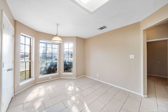 unfurnished dining area featuring light tile patterned floors