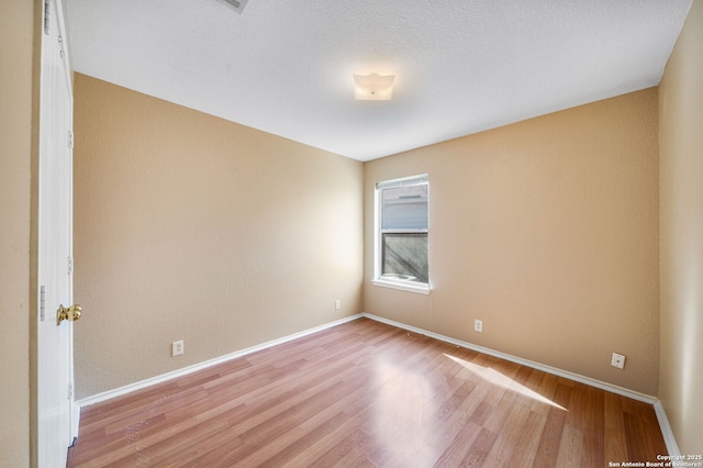 spare room with light hardwood / wood-style flooring