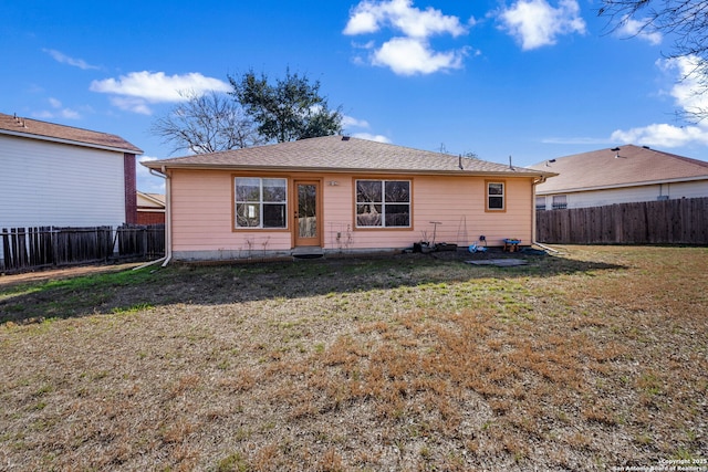 rear view of property with a lawn