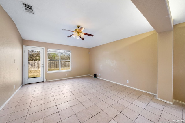 tiled spare room featuring ceiling fan