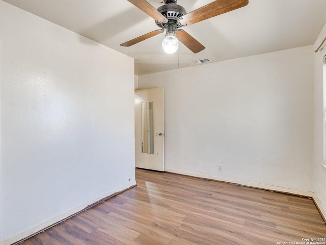 empty room with light hardwood / wood-style floors and ceiling fan