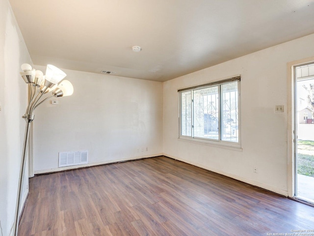 spare room with dark hardwood / wood-style flooring