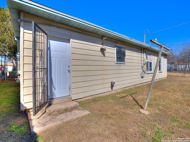 view of side of home with a yard