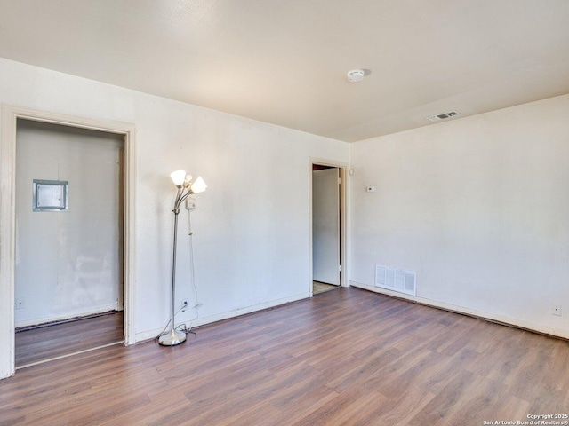 empty room featuring dark wood-type flooring