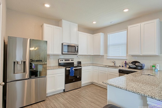 kitchen featuring sink, white cabinets, and appliances with stainless steel finishes