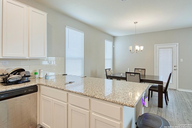 kitchen featuring white cabinetry, decorative light fixtures, dishwasher, and kitchen peninsula