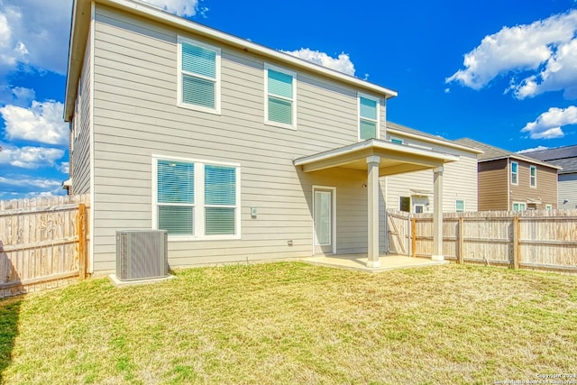 rear view of house featuring central AC, a lawn, and a patio area