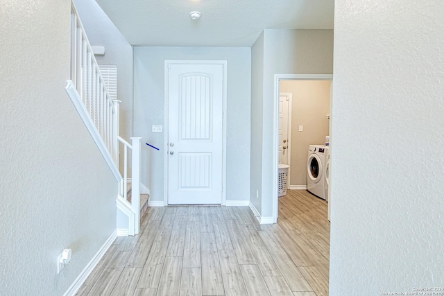 interior space with separate washer and dryer and light hardwood / wood-style floors