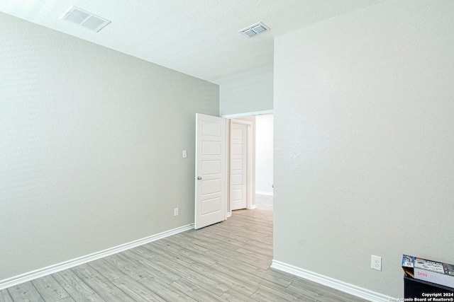 empty room with light hardwood / wood-style flooring