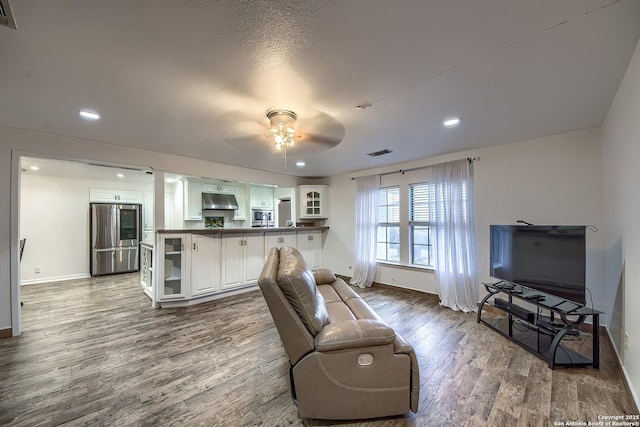 living room with ceiling fan and wood-type flooring