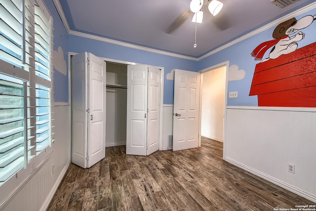 unfurnished bedroom with crown molding, hardwood / wood-style floors, and a closet