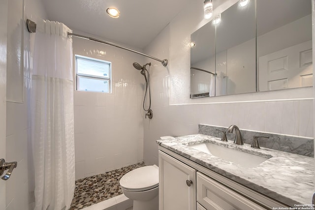 bathroom with vanity, curtained shower, and toilet