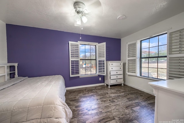 unfurnished bedroom with ceiling fan, dark wood-type flooring, and a textured ceiling