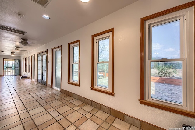 tiled empty room featuring ceiling fan