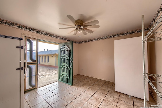 interior space with ceiling fan and light tile patterned flooring