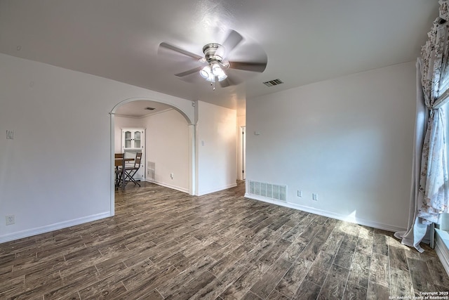 spare room featuring ceiling fan and dark hardwood / wood-style flooring