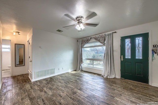 foyer entrance with ceiling fan and dark hardwood / wood-style flooring