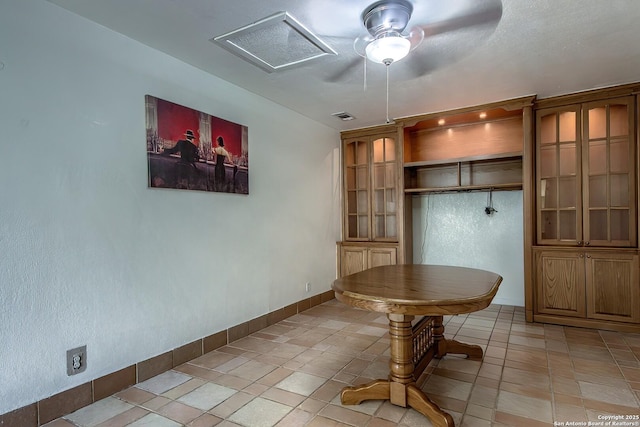 unfurnished dining area featuring light tile patterned floors and ceiling fan