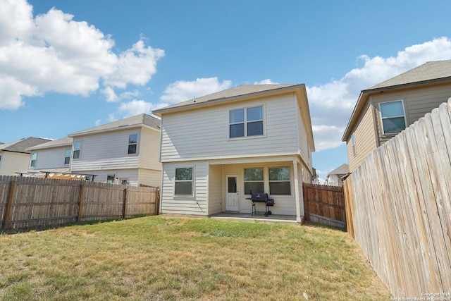 back of property with a patio and a lawn