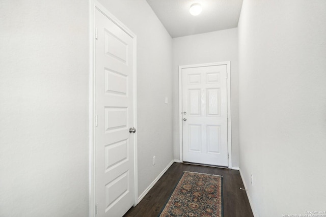 hallway with dark hardwood / wood-style floors