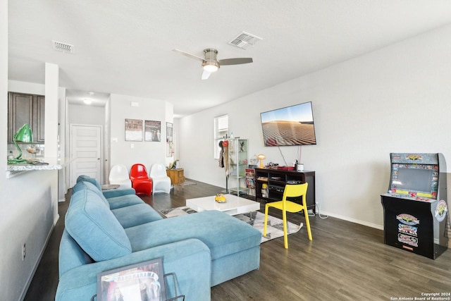 living room with dark hardwood / wood-style flooring and ceiling fan