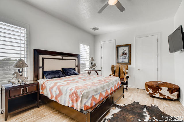 bedroom with ceiling fan and light hardwood / wood-style flooring