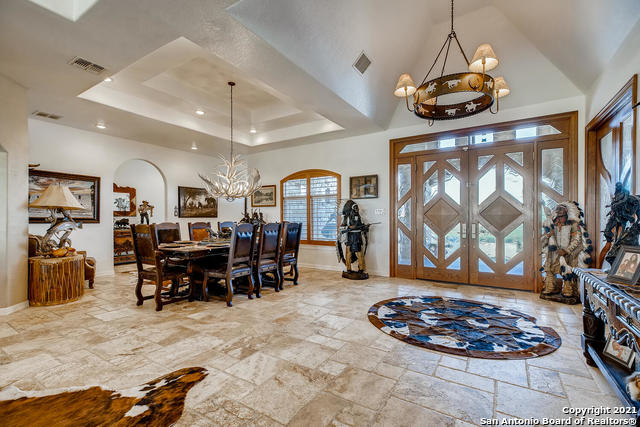 dining area featuring a chandelier and a tray ceiling