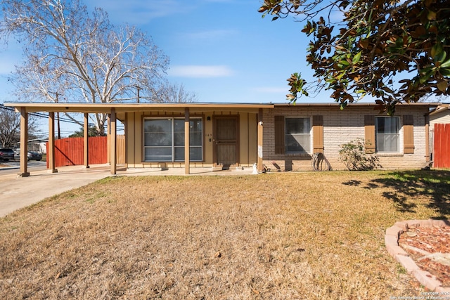 single story home with a carport and a front lawn