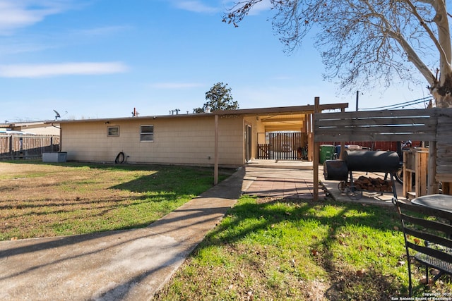 rear view of property featuring a yard and central AC