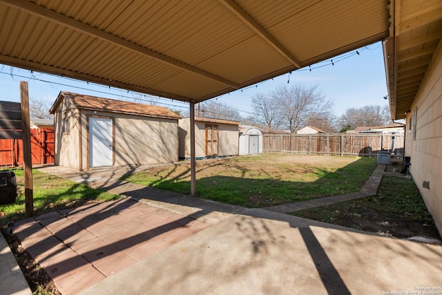 view of yard with a storage shed and a patio