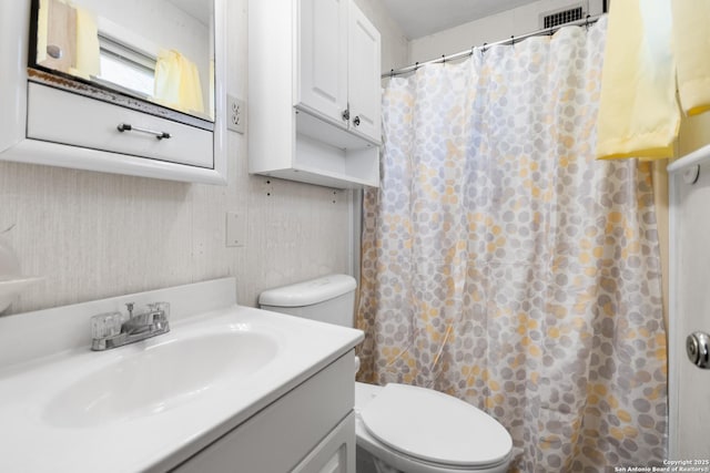 bathroom featuring vanity, toilet, and a shower with shower curtain