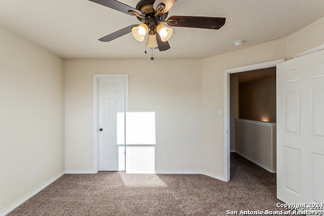 carpeted empty room featuring ceiling fan