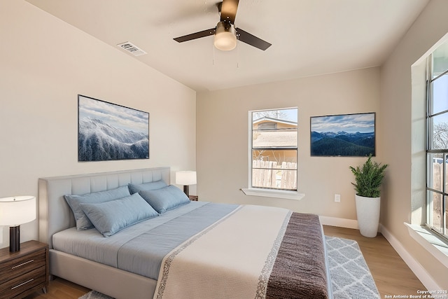 bedroom featuring light hardwood / wood-style floors and ceiling fan