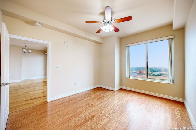 spare room with ceiling fan and light wood-type flooring