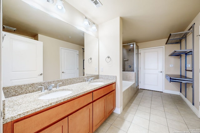 bathroom featuring tile patterned flooring, vanity, and separate shower and tub