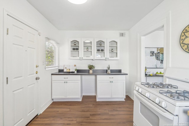 kitchen featuring white cabinetry, dark hardwood / wood-style flooring, and gas range gas stove