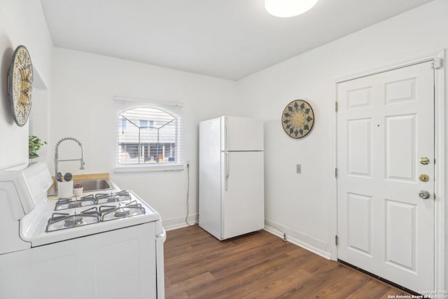 kitchen featuring sink, white appliances, and dark hardwood / wood-style floors