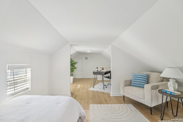 bedroom featuring vaulted ceiling and light hardwood / wood-style floors