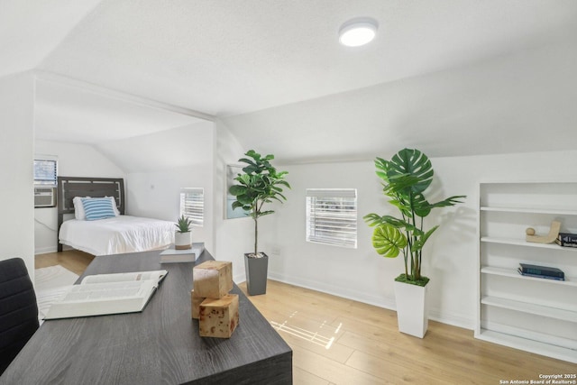 bedroom featuring vaulted ceiling and light hardwood / wood-style floors