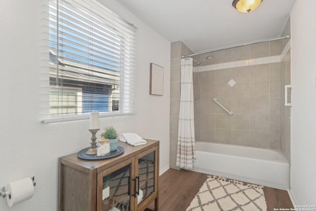 bathroom with shower / tub combo with curtain and wood-type flooring