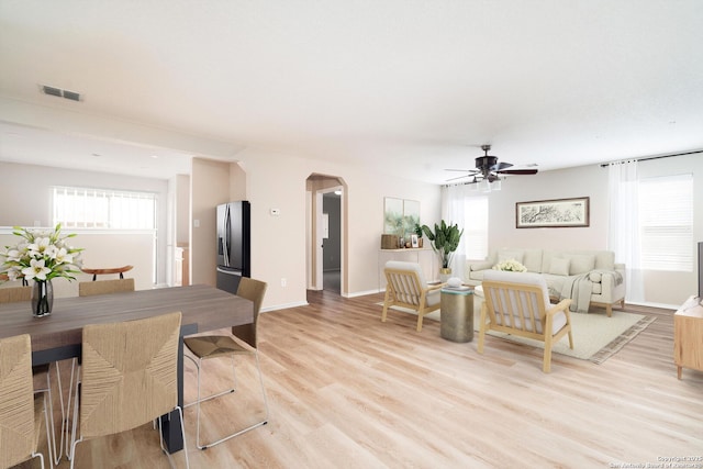 living room with ceiling fan and light hardwood / wood-style flooring