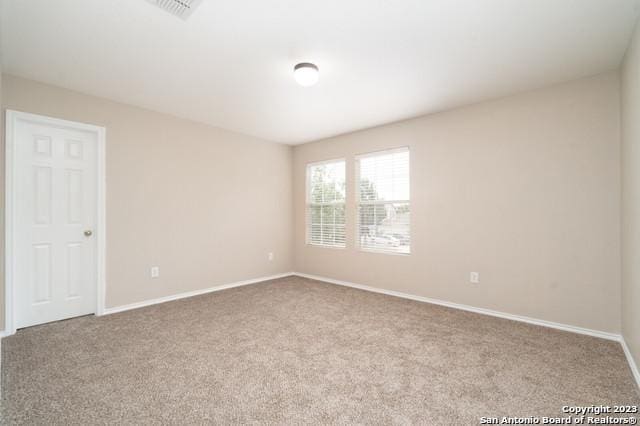 unfurnished room with light colored carpet