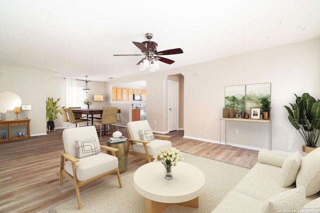 living room featuring hardwood / wood-style flooring and ceiling fan