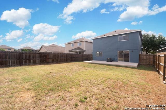 back of property with a patio and a lawn