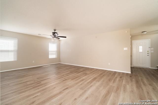 unfurnished room with wood-type flooring and ceiling fan