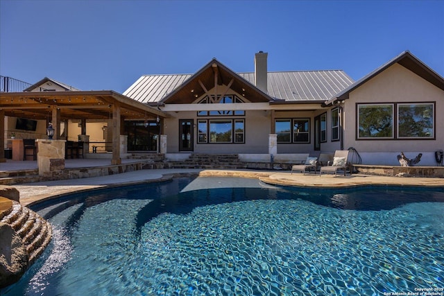 view of swimming pool featuring an outdoor bar and a patio area